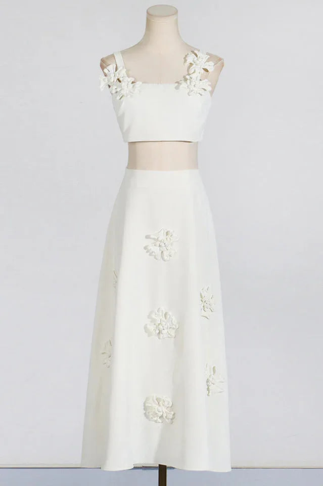Mannequin wearing a white floral applique cropped top and A-line skirt