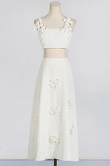 Mannequin wearing a white floral applique cropped top and A-line skirt