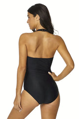 Back view of a woman in a black one-piece swimsuit
