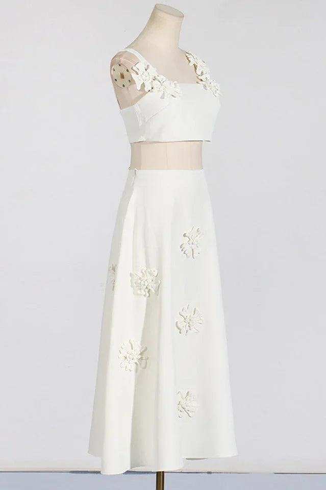 Mannequin wearing a white floral applique cropped top and A-line skirt, side view