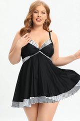 Plus-size black swim dress with polka dot trim and twisted front