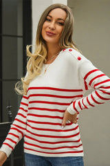 Close-up of a woman wearing a white and red striped knit sweater with a crew neck and button details on the shoulders.