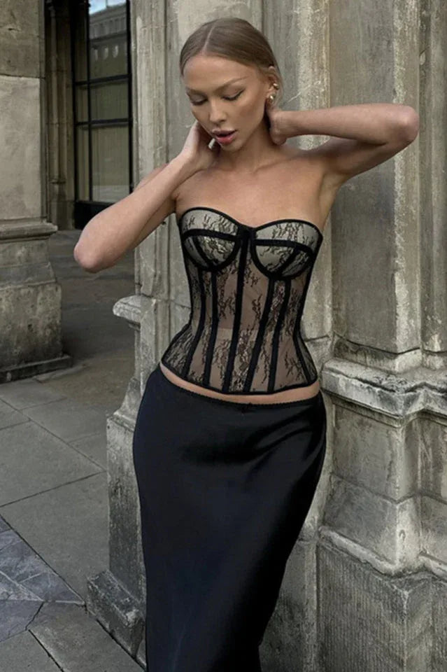 Woman wearing a black lace corset top and a black skirt outdoors