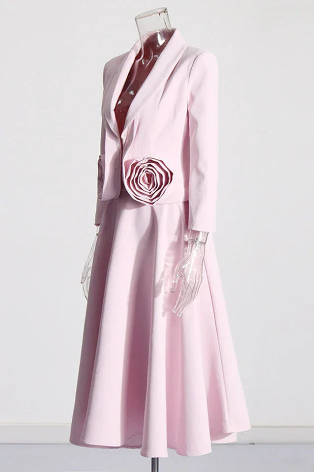 Side view of a pink blazer and skirt set with rose embellishments on a mannequin