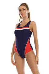 Woman wearing a navy and red athletic one-piece swimsuit