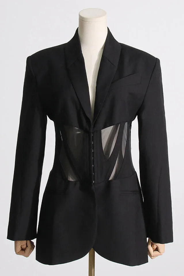 Front close-up of black fitted blazer with sheer corset detail on a mannequin