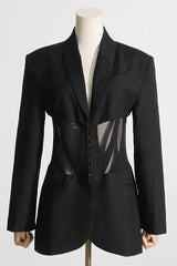 Front close-up of black fitted blazer with sheer corset detail on a mannequin