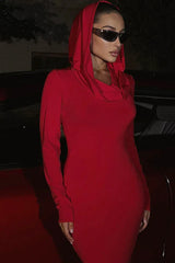 Close-up of a woman's face wearing a red hooded dress and sunglasses.
