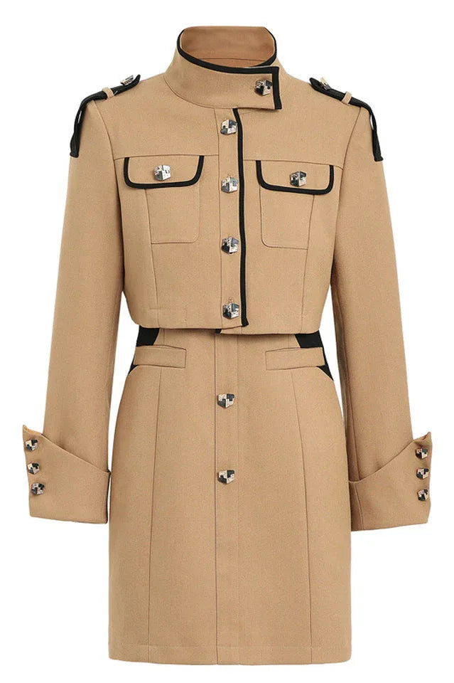 Flat lay of a beige cropped jacket and matching mini dress with button detailing and black trim
