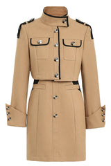 Flat lay of a beige cropped jacket and matching mini dress with button detailing and black trim