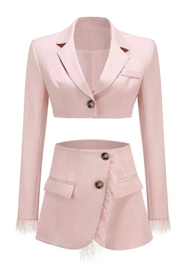 Pink cropped blazer and asymmetrical skirt with feather trim laid flat, front view