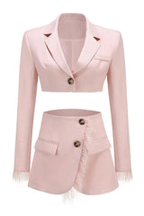 Pink cropped blazer and asymmetrical skirt with feather trim laid flat, front view