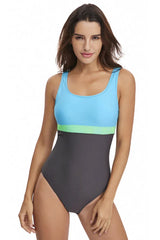 Woman wearing a grey, light blue, and lime green color-blocked one-piece swimsuit, front view.