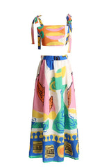Flat lay of a matching crop top and maxi skirt set with an abstract print