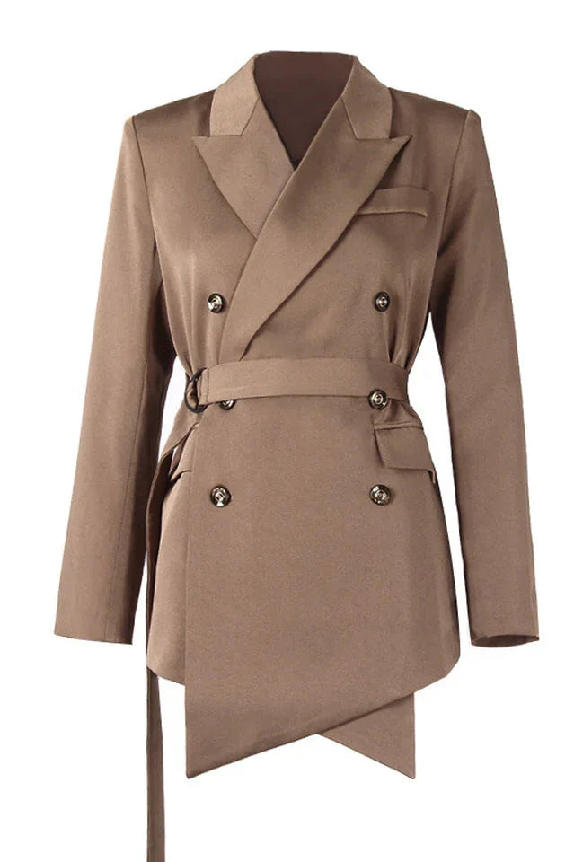 Studio shot of a brown double-breasted blazer with a belted waist and asymmetrical hem.