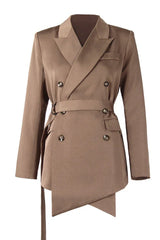 Studio shot of a brown double-breasted blazer with a belted waist and asymmetrical hem.
