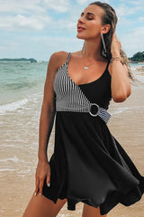 Woman wearing a royal blue swimdress with geometric pattern accent on a beach