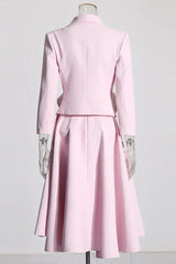 Back view of a pink blazer and skirt set with rose embellishments on a mannequin