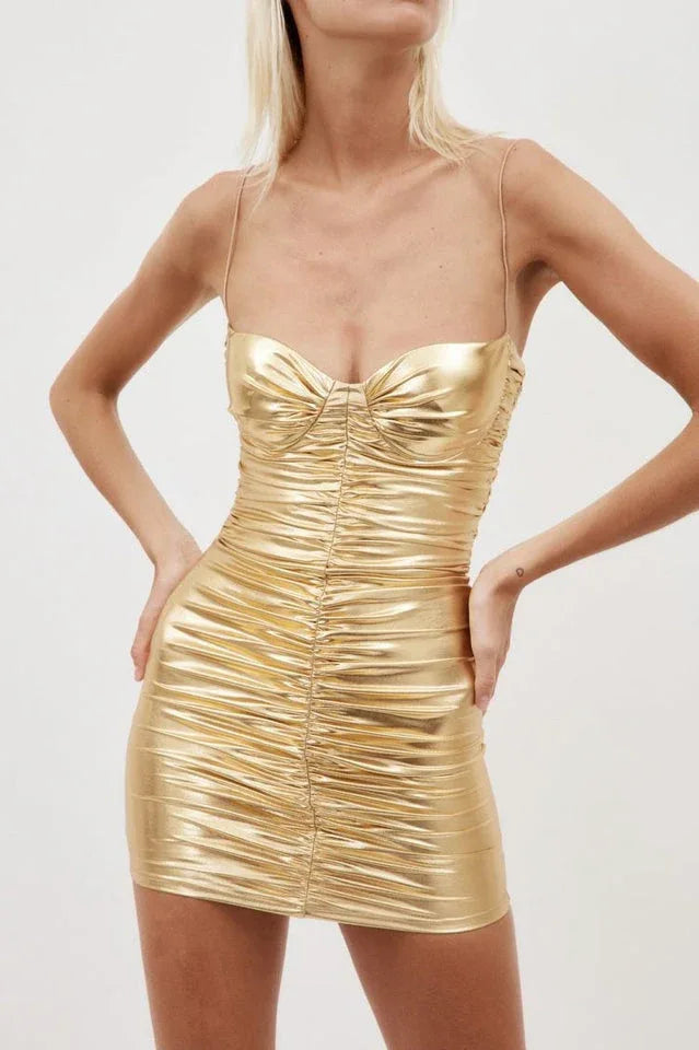 Close-up front view of a woman's torso in a gold metallic ruched mini dress with a sweetheart neckline and thin straps.