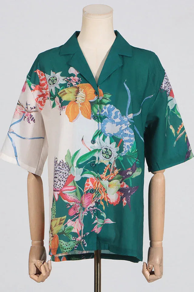 Front view of a green and white floral print camp collar shirt on a mannequin.