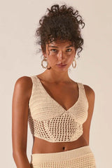 Close-up of the woman's face and the crochet knit crop top.