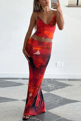 Woman wearing a red floral print crop top and matching maxi skirt