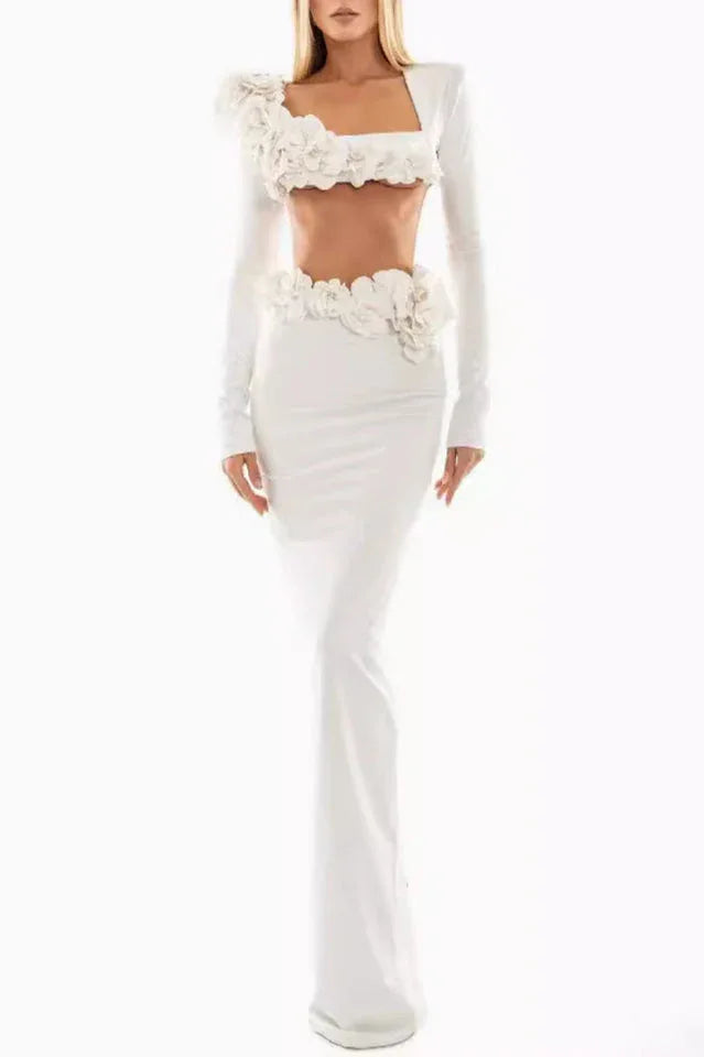 Full length view of a woman wearing a white two-piece formal gown with floral embellishments.