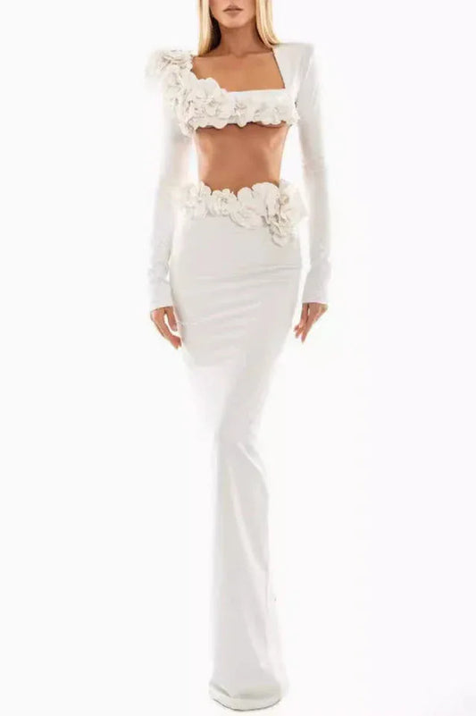 Full length view of a woman wearing a white two-piece formal gown with floral embellishments.
