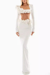 Full length view of a woman wearing a white two-piece formal gown with floral embellishments.