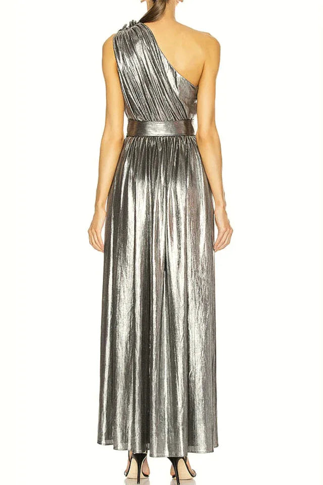 Back view of a model in a silver metallic one-shoulder gown with a floor-length skirt.