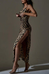 Woman in a leopard print satin maxi dress with a high slit, adjusting the top of the dress.