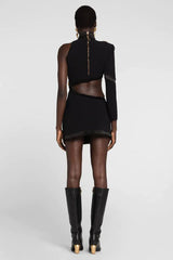 Back view of the black asymmetrical mini dress revealing the cut-out detailing and zipper closure.