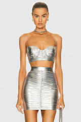 Front view of a woman wearing a silver metallic ruched bustier top and matching ruched mini skirt.