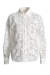 Close-up of a sheer white lace button-down shirt with floral embroidery.