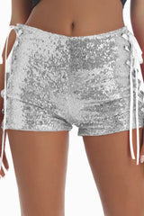 Front view of silver sequined shorts with white lace-up sides.