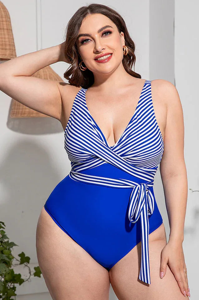 Plus-size one-piece swimsuit with blue and white stripes on the bodice and a blue bottom.