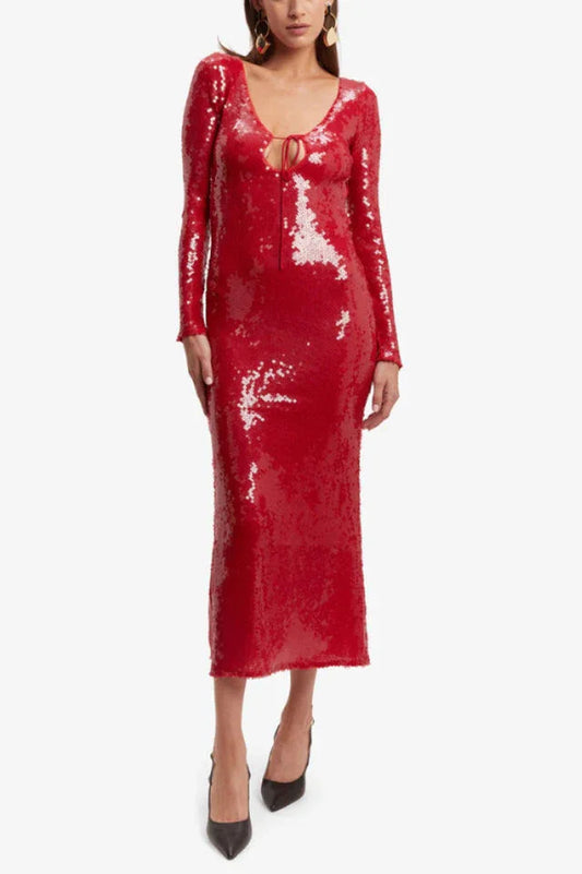 Woman wearing a long-sleeved, red sequined midi dress with a tie-front neckline, shown from the front.
