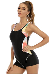 Close-up of a woman's torso in a black one-piece swimsuit with colorful side panels.