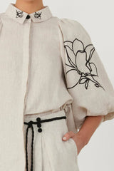 Detail of the embroidered flowers on the wide-leg linen pants