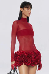 Close-up of a model in a red sheer mini dress with ruffled hem