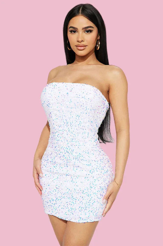 Woman wearing a strapless white sequin mini dress, front view
