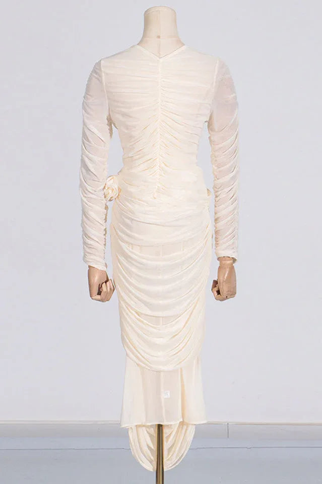 Back view of a cream ruched mesh dress on a mannequin