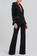 Close-up of a black formal suit jacket with 3D floral embellishments on the sleeves