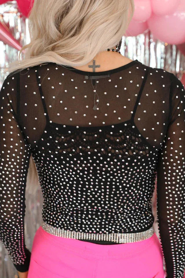 Back view of a woman wearing a black rhinestone mesh bodysuit