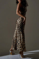 Side view of a woman in a leopard print satin maxi dress with a high slit, showcasing the back detail.