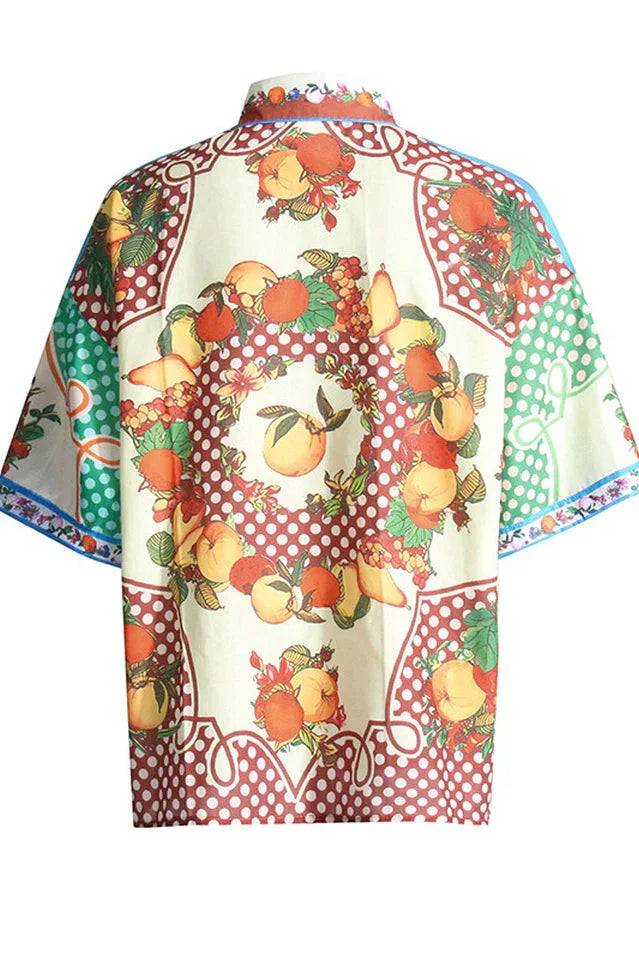 Back view of a fruit print short-sleeve collared shirt with a fruit wreath design.