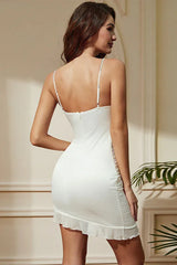 Rear view of a woman wearing a white satin bodycon dress with a zipper closure and ruffled hem detail.