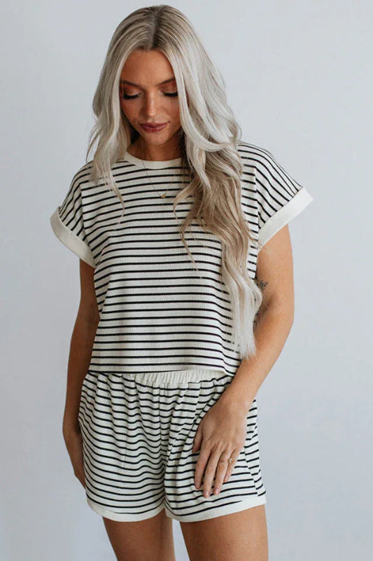 Woman wearing a black and white striped loungewear set, front view