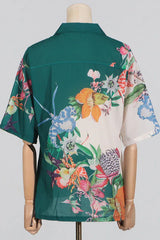 Back view of a green and white floral print camp collar shirt on a mannequin.