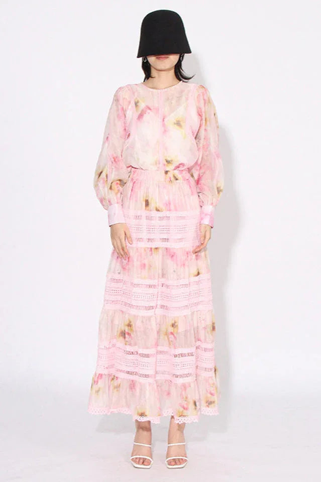 Woman wearing a pink floral print maxi dress from the front